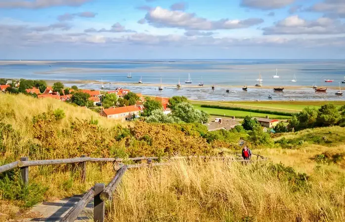 Looking across the Wadden Sea from the Frisian Island of Vlieland during sunset on a summer night. The Frisian Islands are also known as the Wadden Islands or Wadden Sea Islands