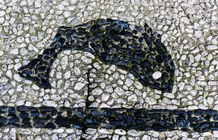 Century old traditional pebble patterns form the sidewalks in the fishing town. The pavement is made with Ilmenite (black) and quarz (white) pebbles