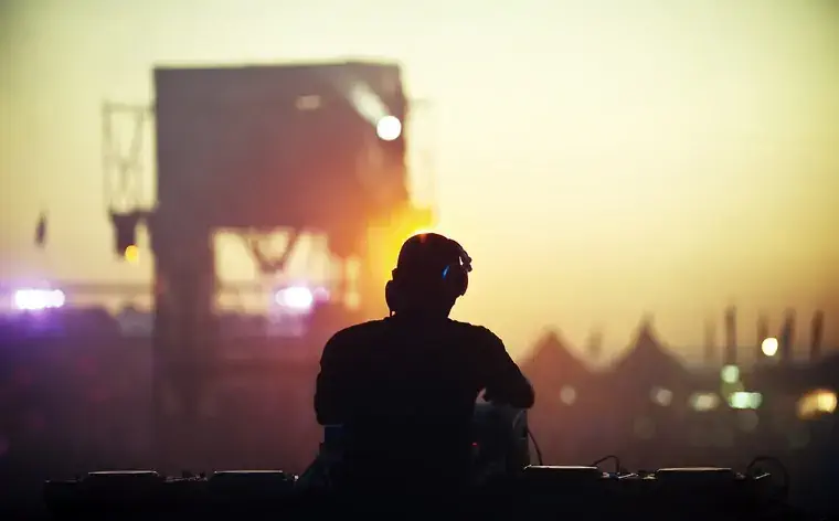 DJ playing at electronic festival.