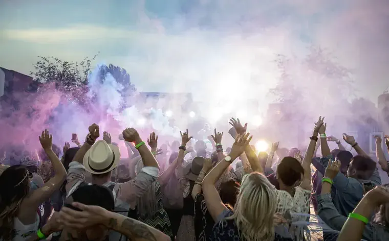 Powder over dancing crowd at summer music festival
